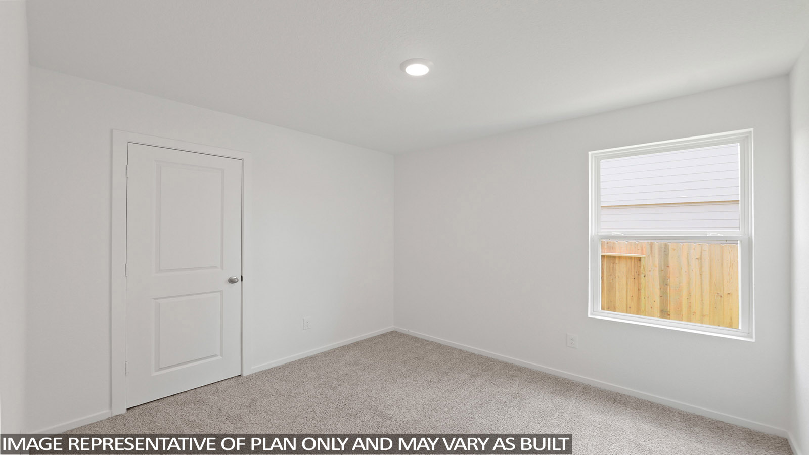 Secondary bedroom with carpet flooring