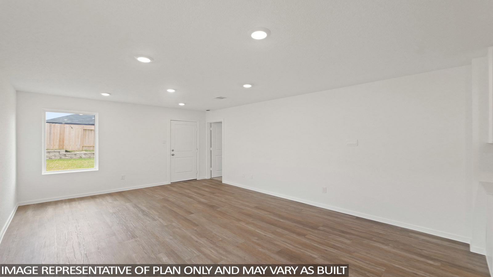 Spacious living area with vinyl flooring