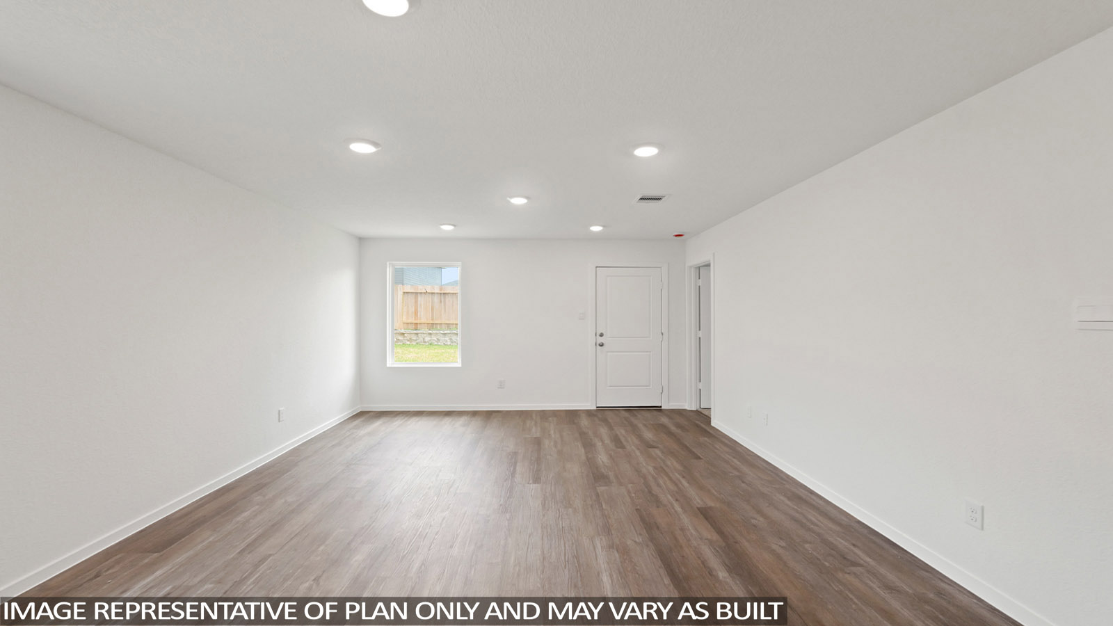 Spacious living area with vinyl flooring