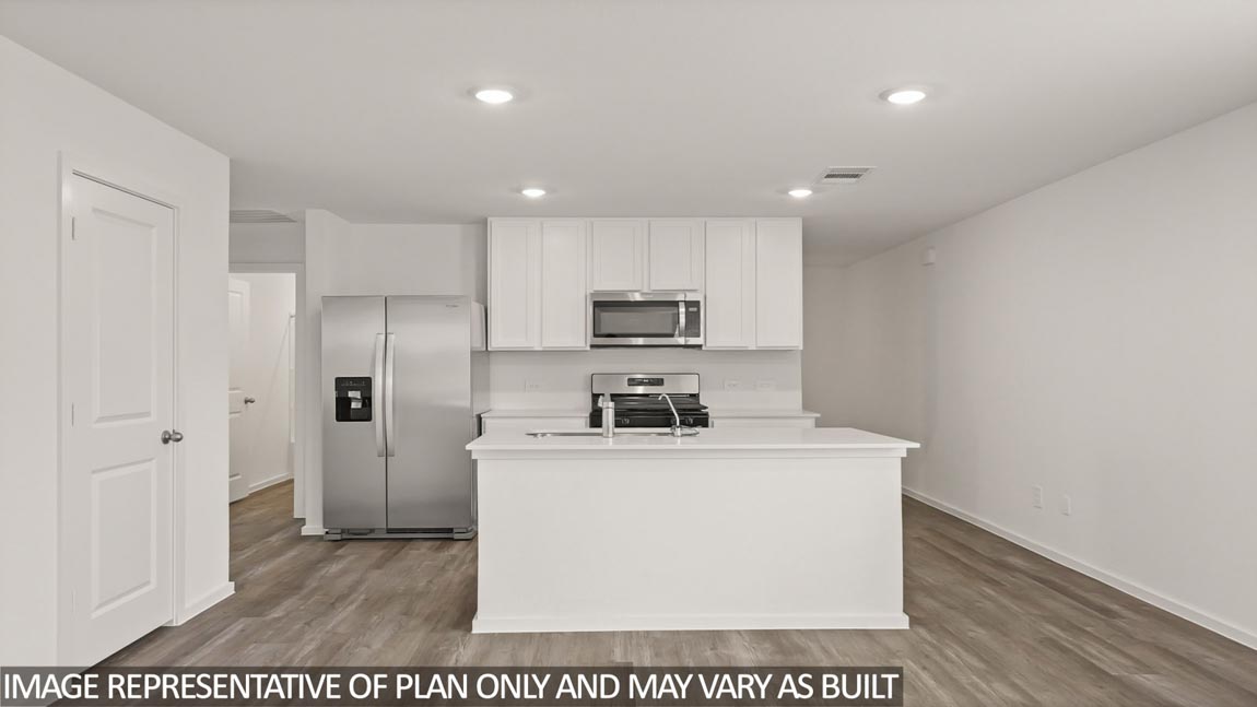 Kitchen with an island and vinyl floor
