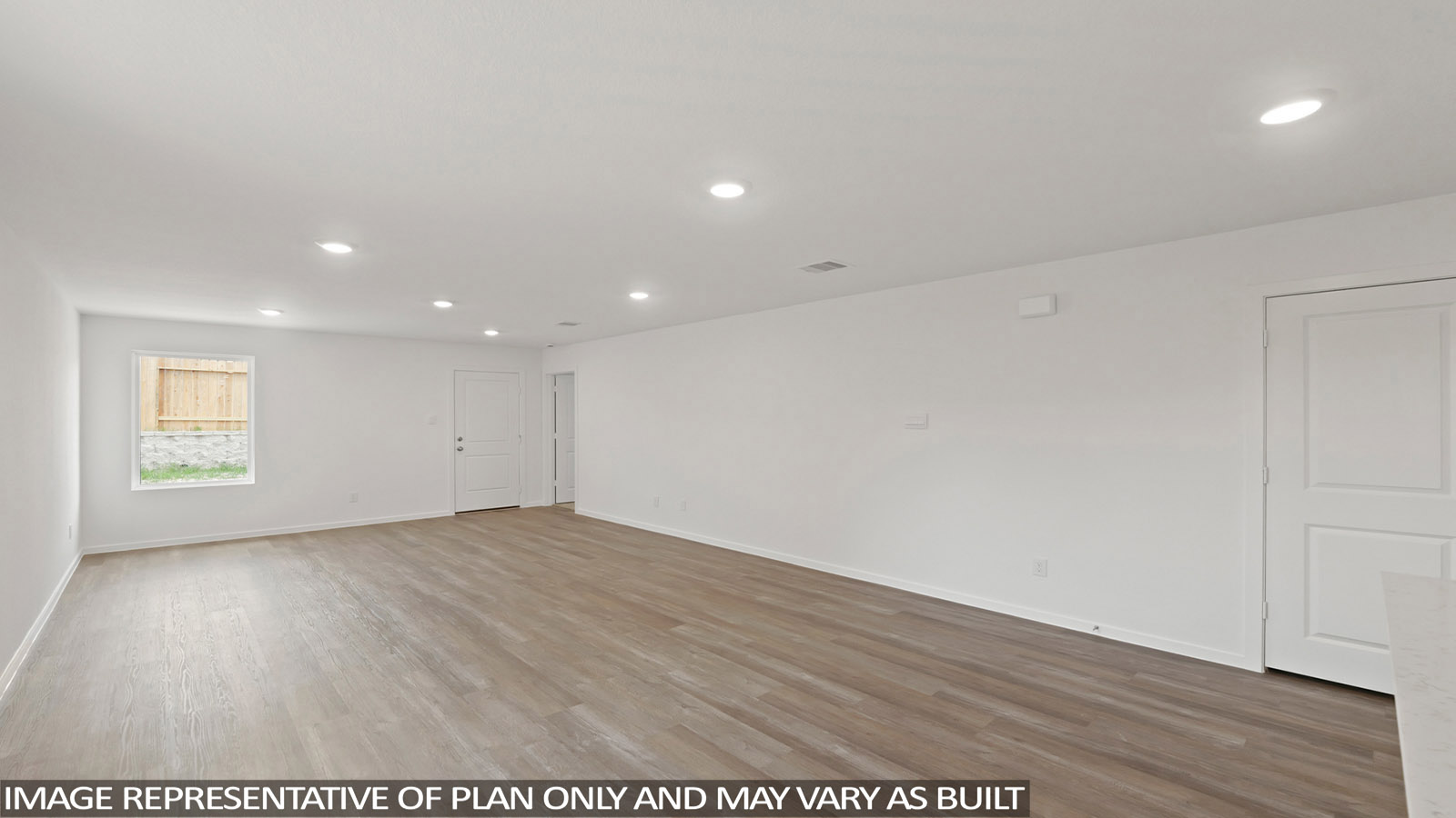 Spacious living area with vinyl flooring