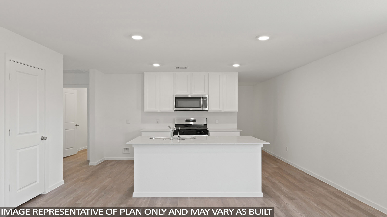 Kitchen with quartz countertops and an island and vinyl floor
