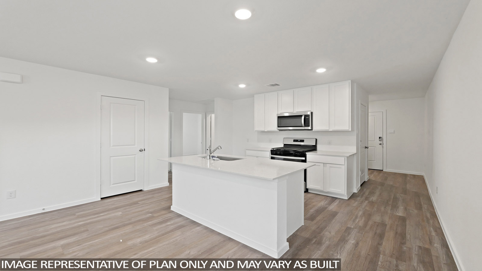 Kitchen with quartz countertops and an island and vinyl floor