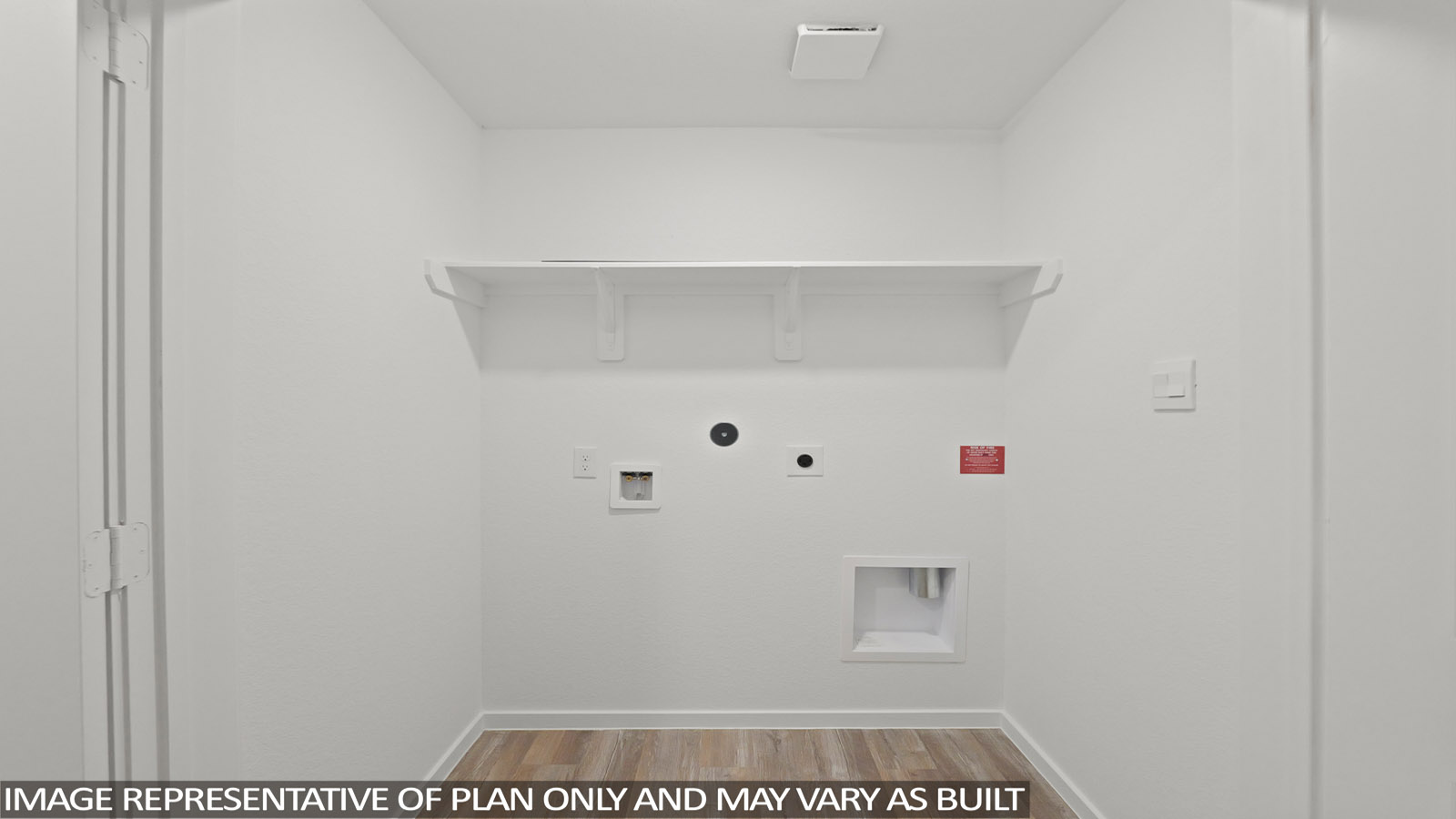 Utility room with storage located off the entry hallway and garage door