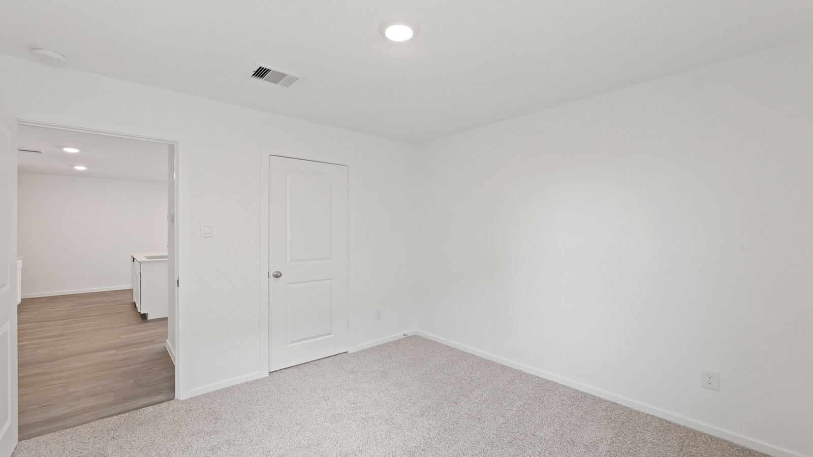Secondary bedroom with carpet flooring