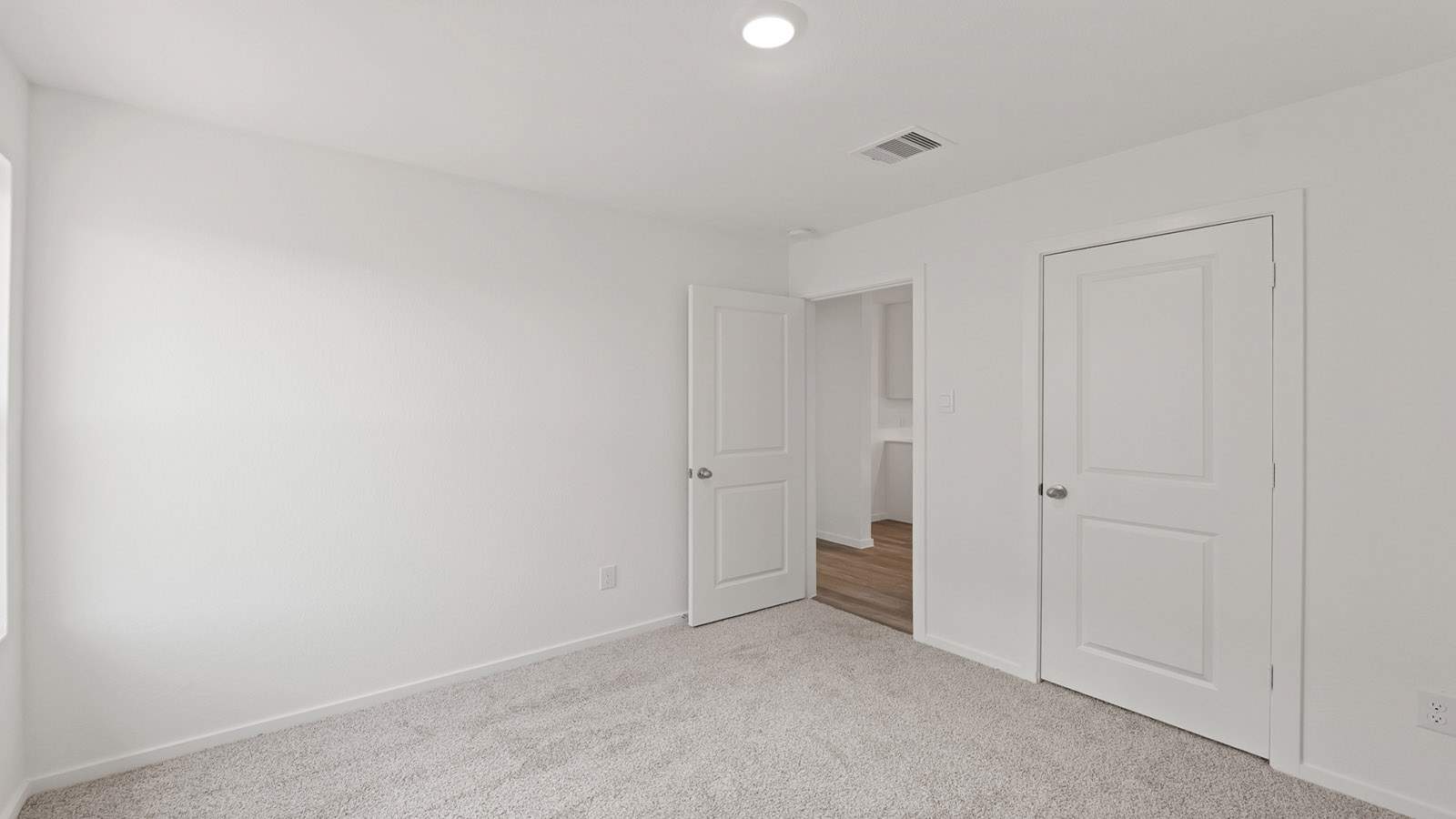 Secondary bedroom with carpet flooring