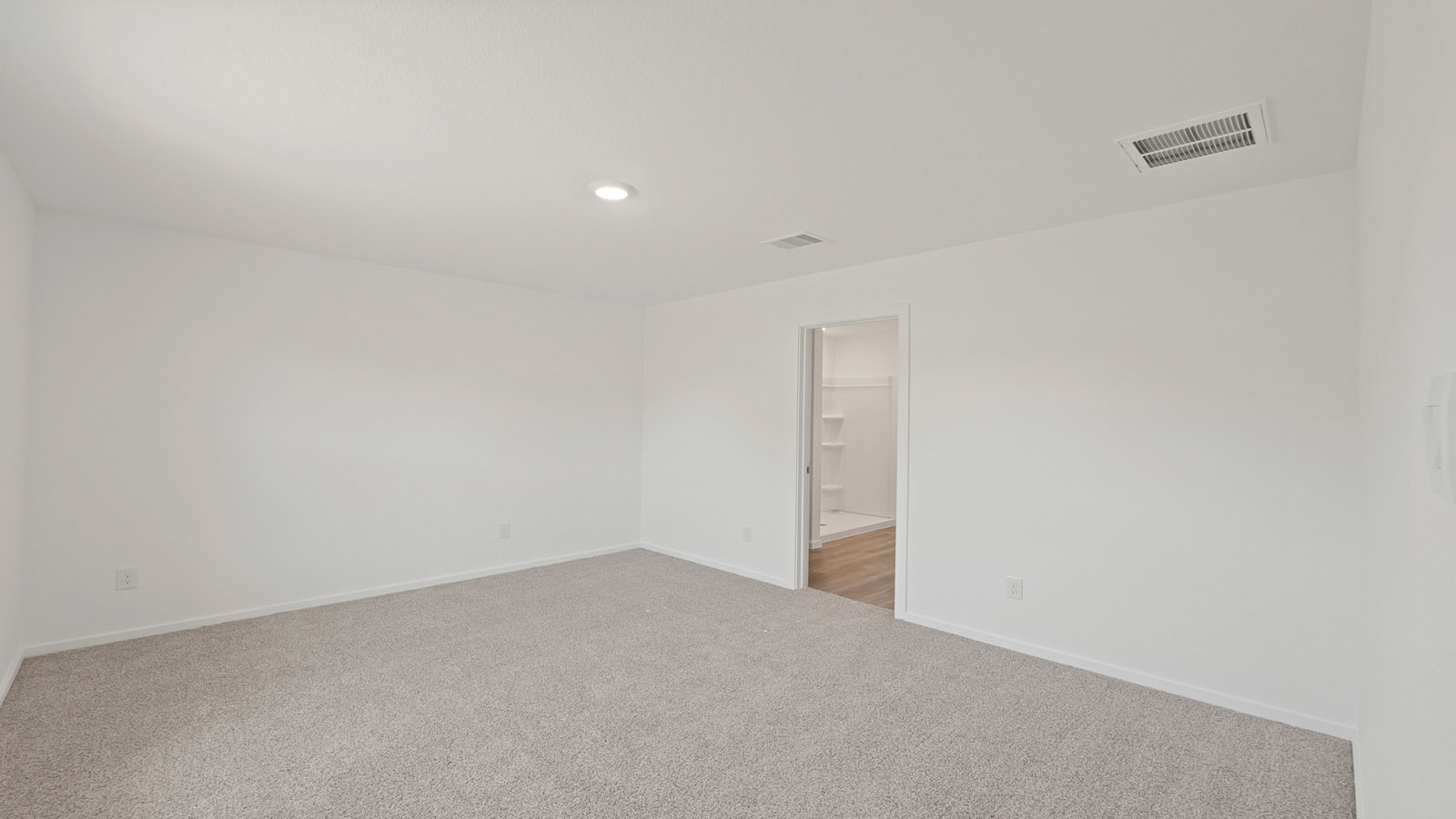 Secondary bedroom with carpet flooring