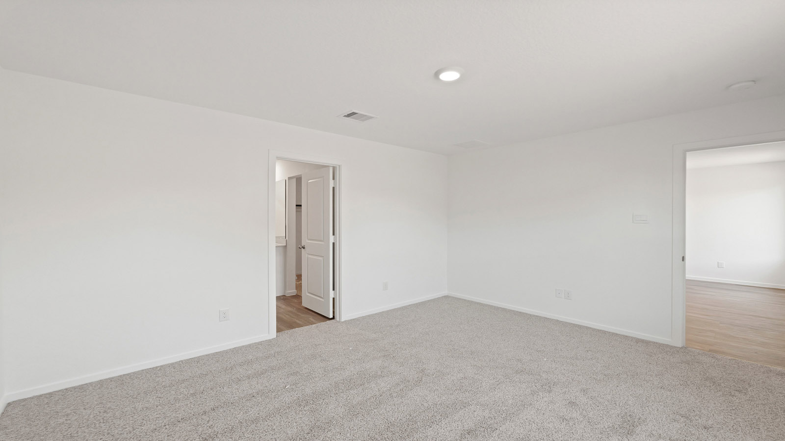 Secondary bedroom with carpet flooring