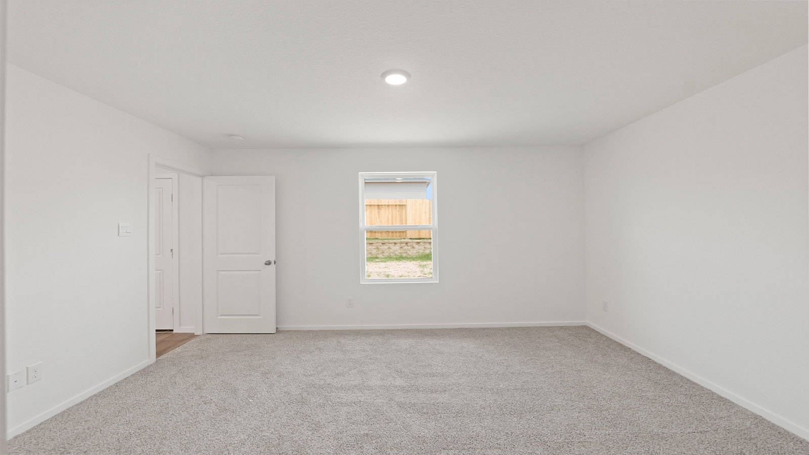 Primary bedroom with carpet flooring