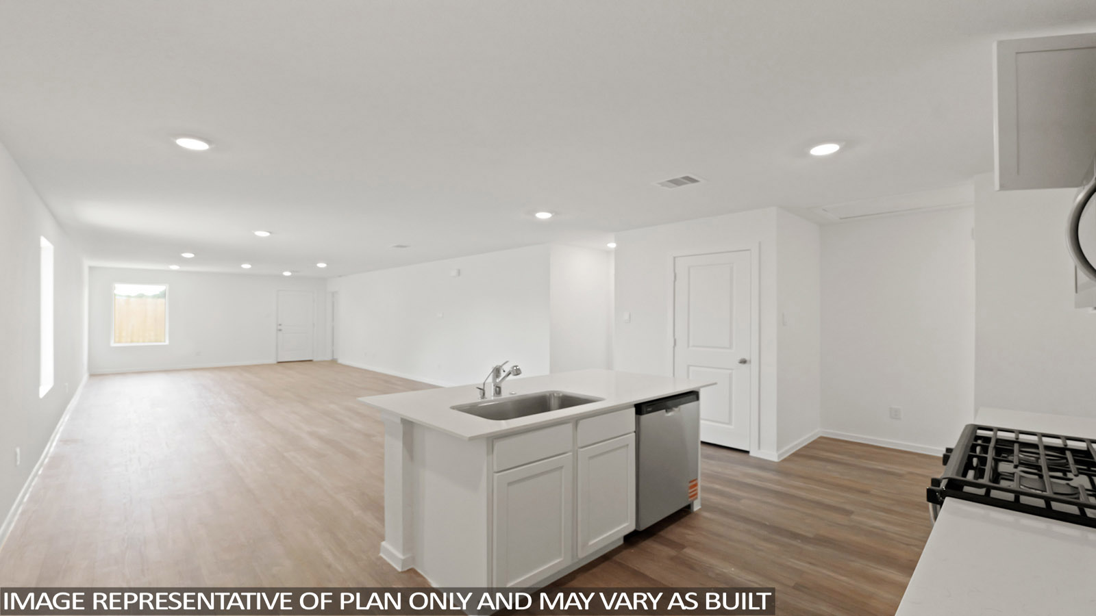 Kitchen with quartz countertops and an island and vinyl floor