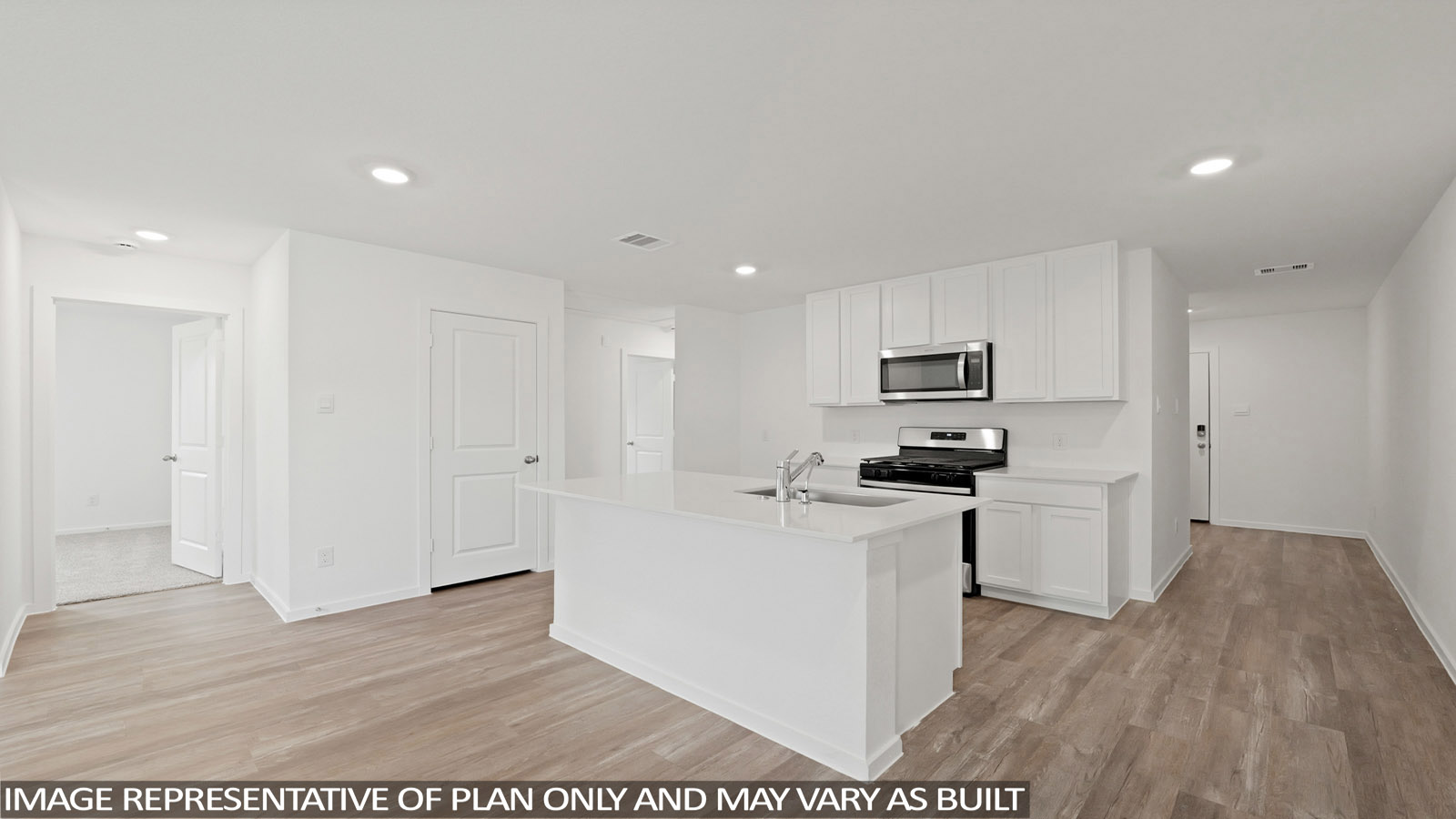Kitchen with quartz countertops and an island and vinyl floor