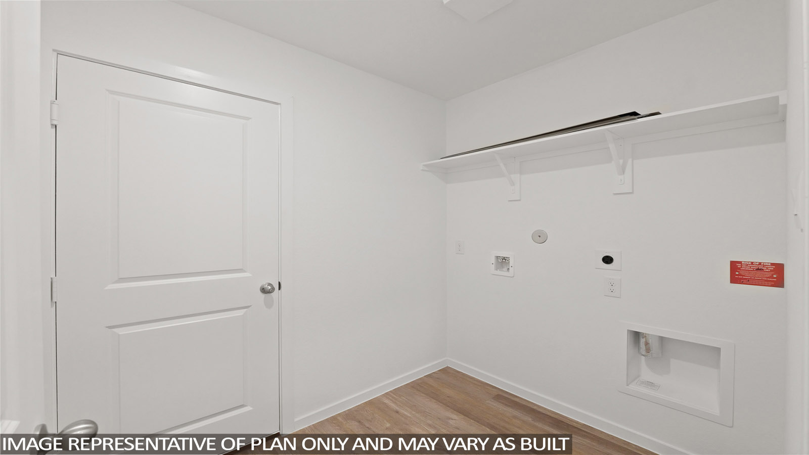 Utility room with storage located off the entry hallway and garage door