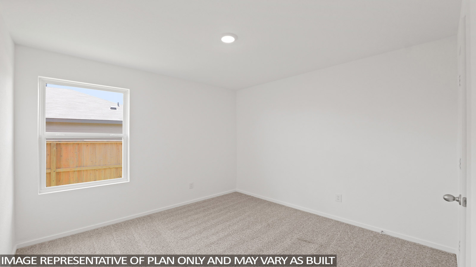 Second level secondary bedroom with carpet flooring and bright window