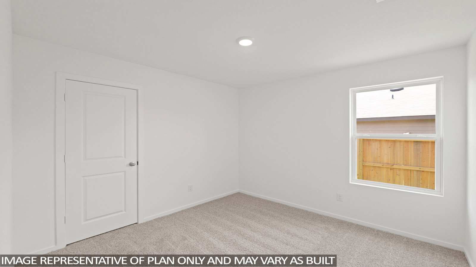 Second level secondary bedroom with carpet flooring and bright window