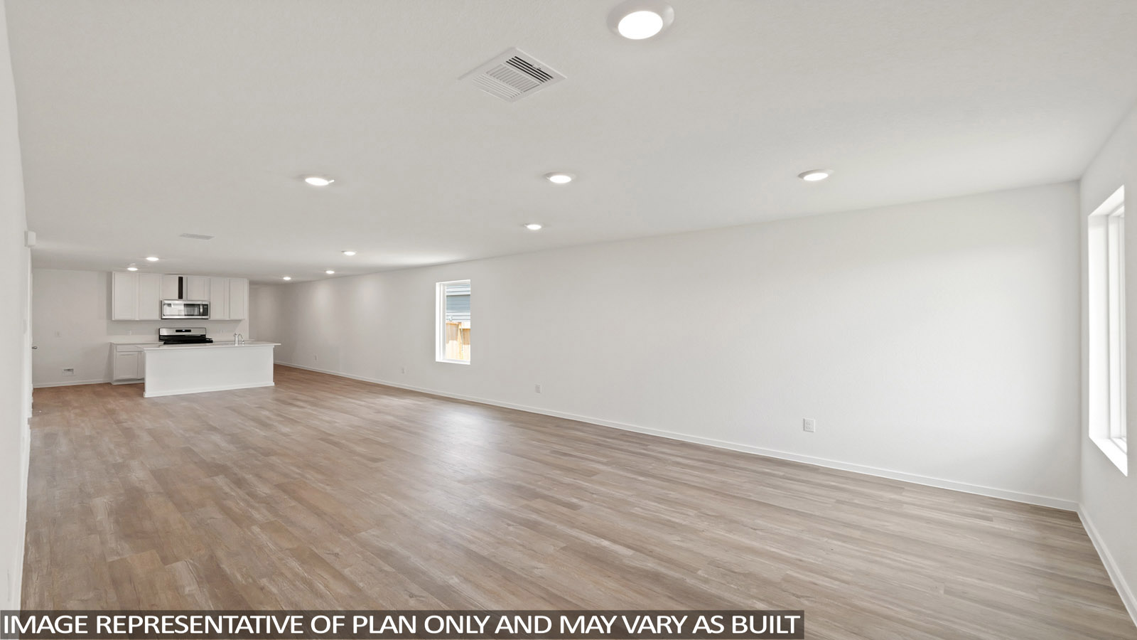 Open concept living, dining, and kitchen area with vinyl flooring and bright windows