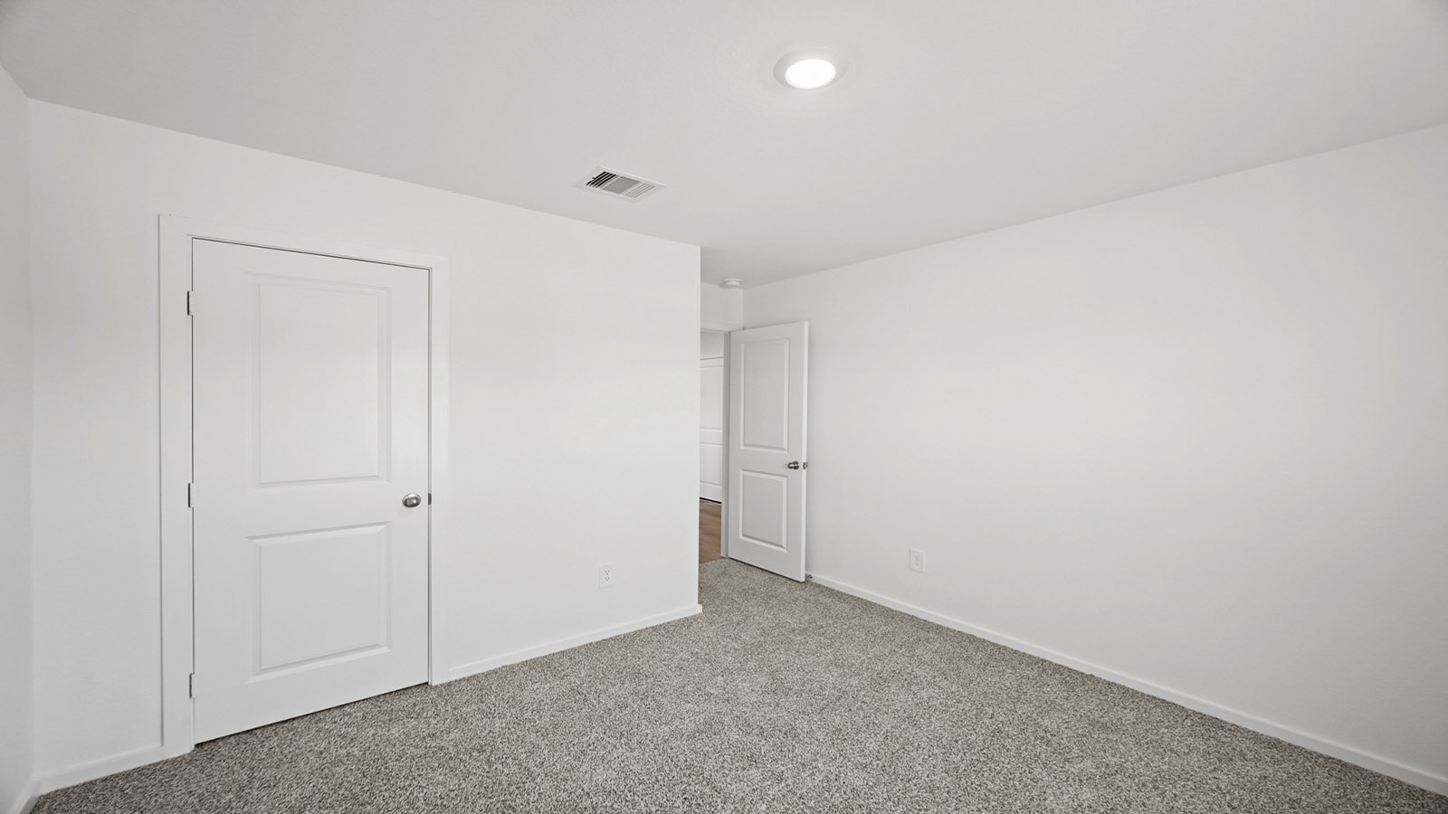Secondary bedroom with carpet flooring