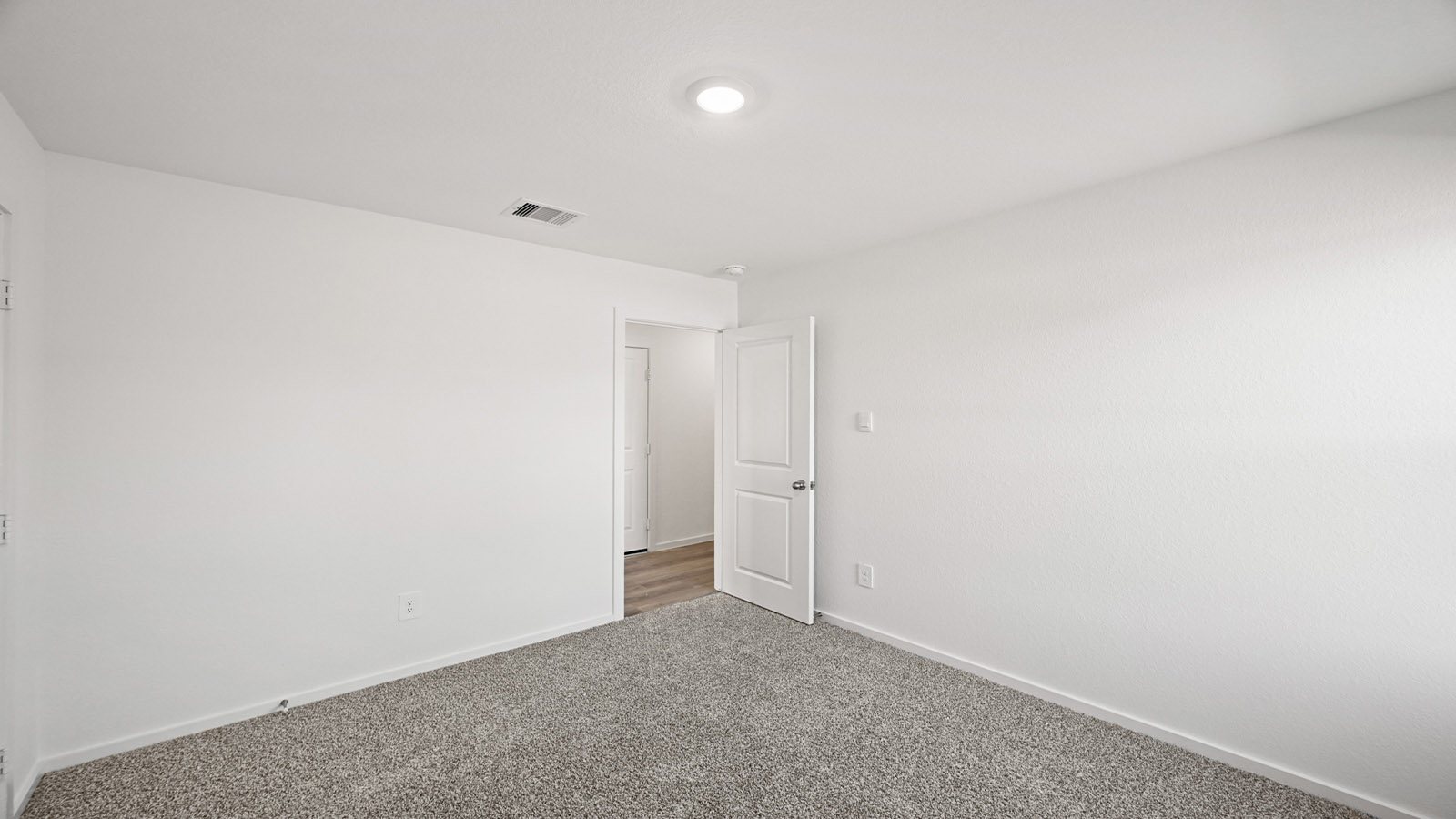 Secondary bedroom with carpet flooring