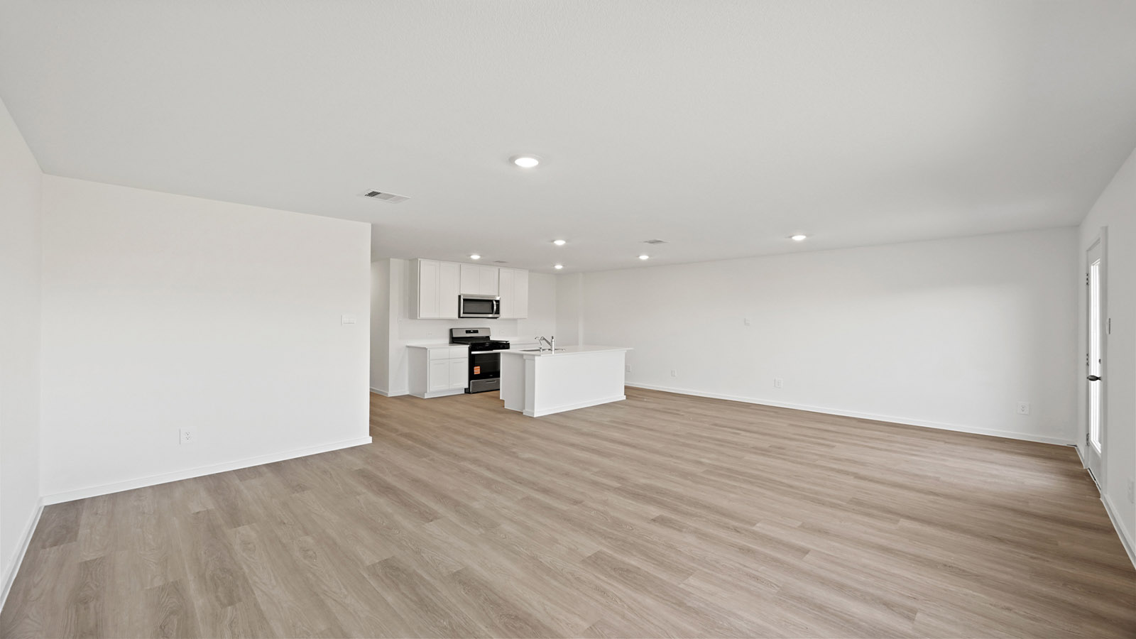 Spacious living area with vinyl flooring