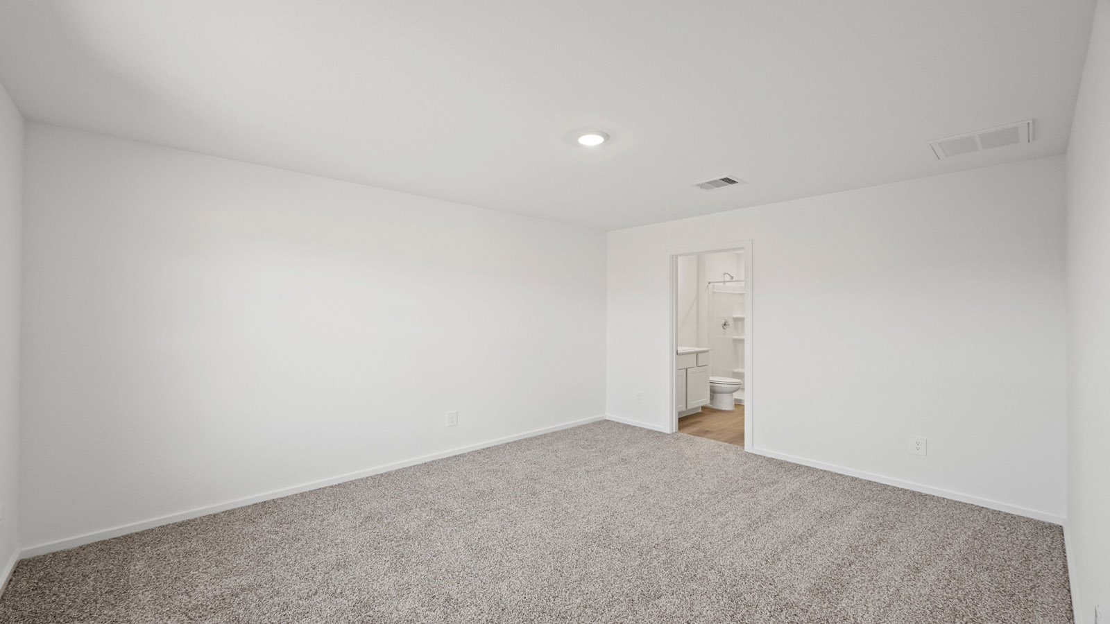 Primary bedroom with carpet flooring