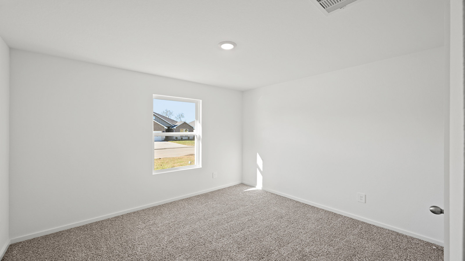 Secondary bedroom with carpet flooring