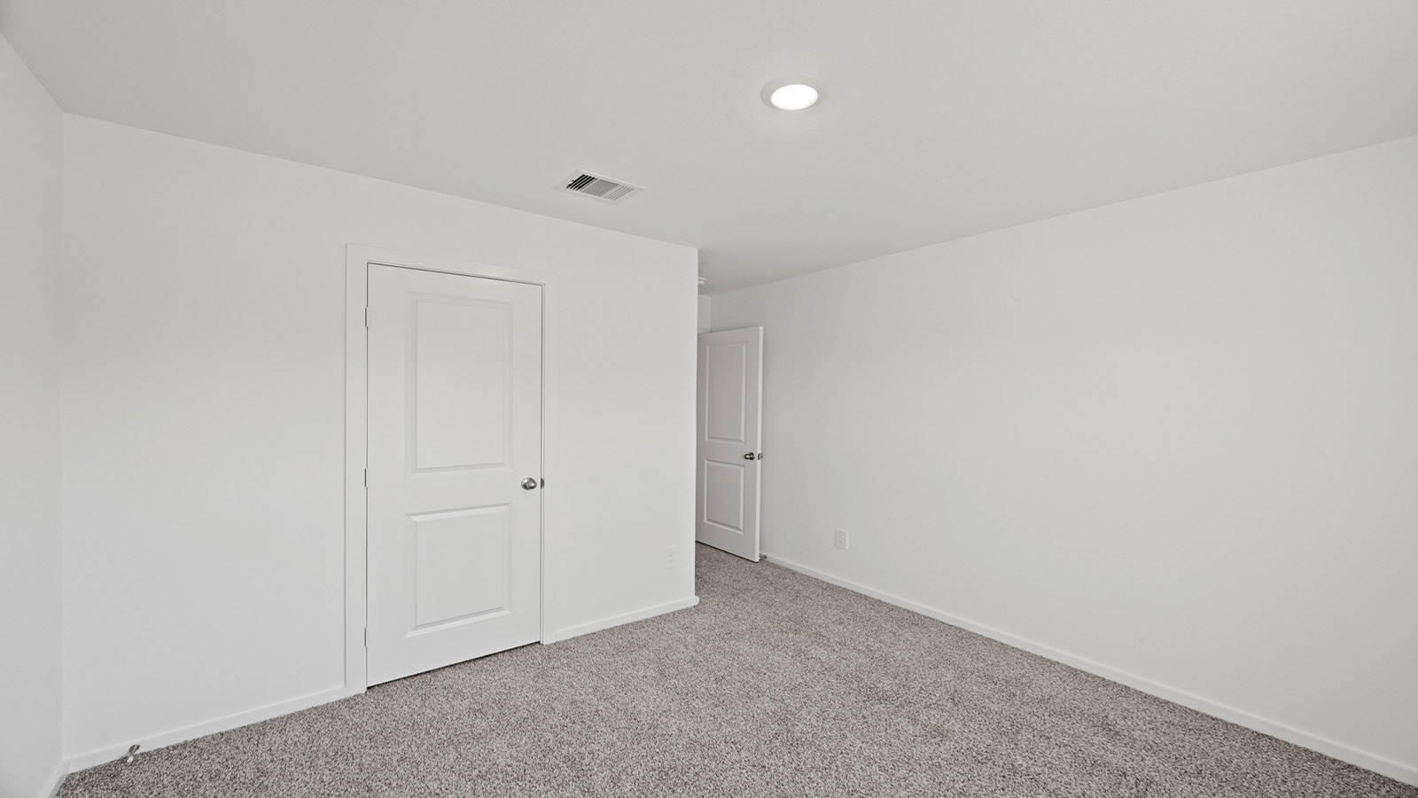 Secondary bedroom with carpet flooring