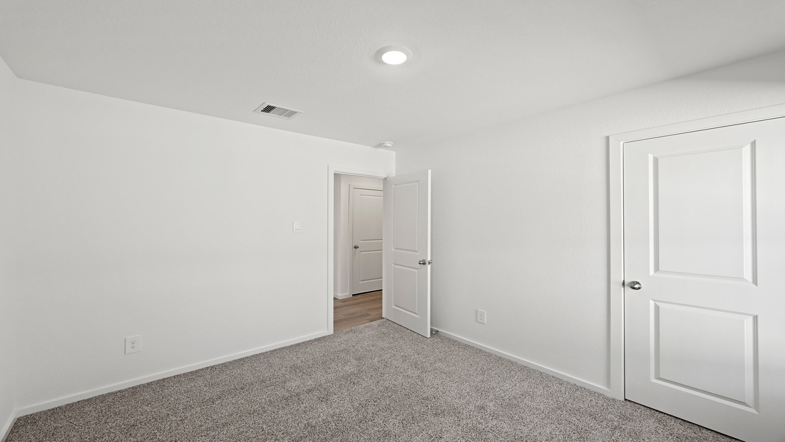 Secondary bedroom with carpet flooring