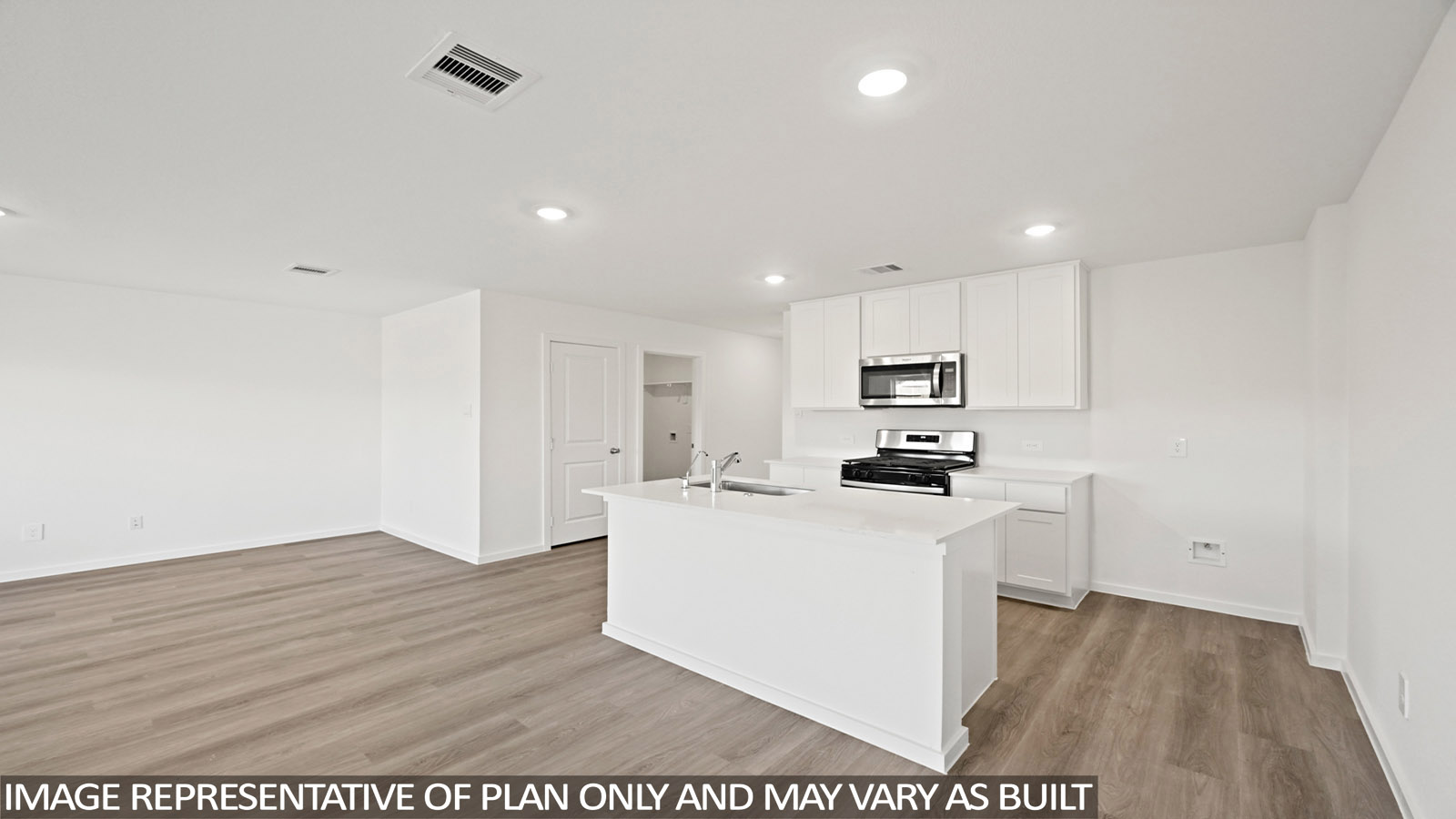 Kitchen with quartz countertops and an island and vinyl floor