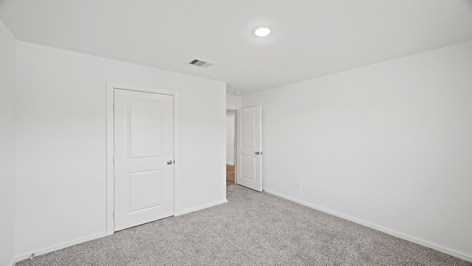 Secondary bedroom with carpet flooring