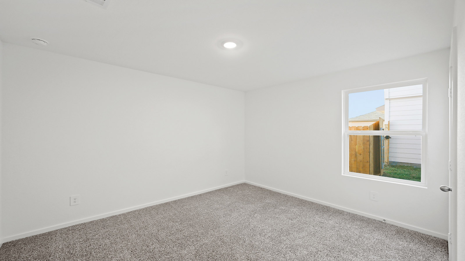 Secondary bedroom with carpet flooring