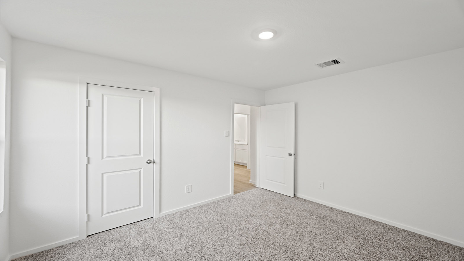 Secondary bedroom with carpet flooring