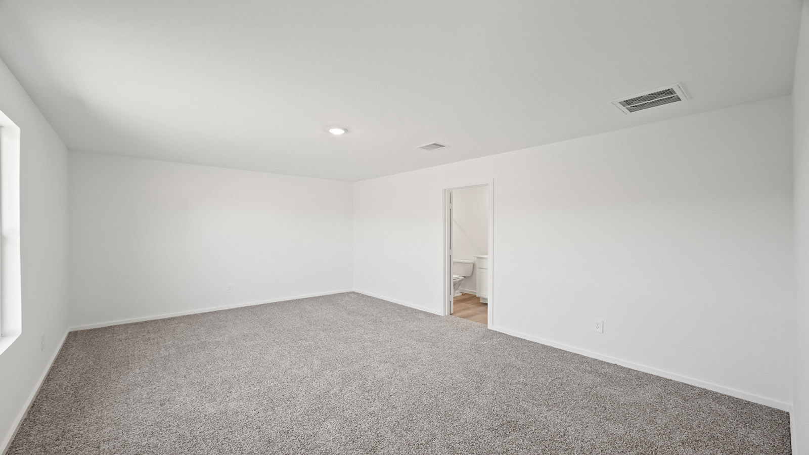 Primary bedroom with carpet flooring