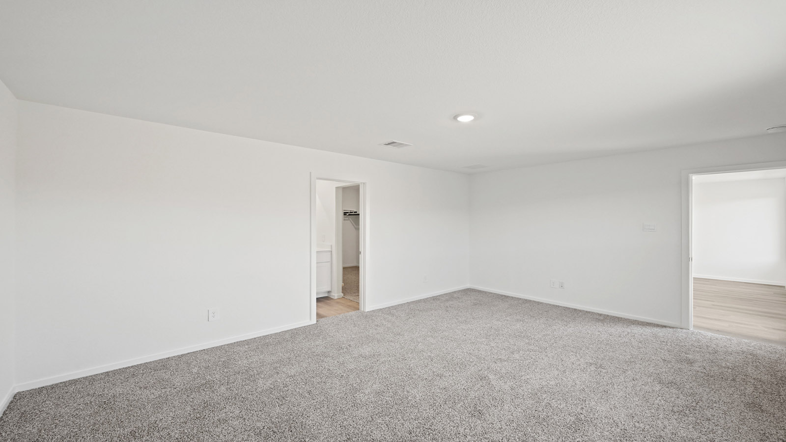 Primary bedroom with carpet flooring