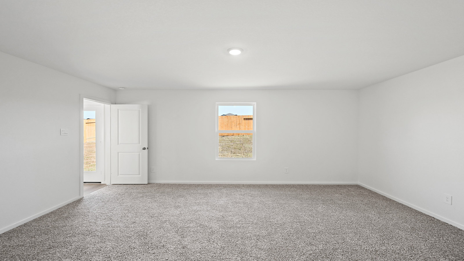 Primary bedroom with carpet flooring