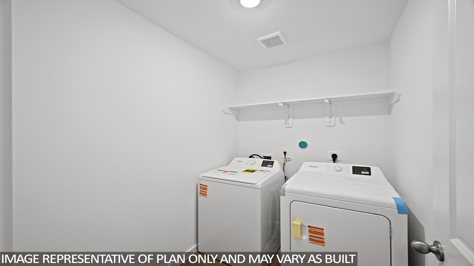 Utility room with storage located off the entry hallway and garage door
