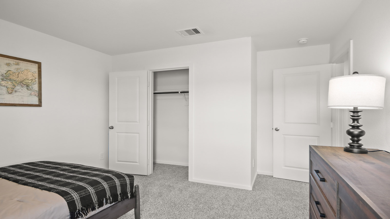 Secondary bedroom with carpet flooring