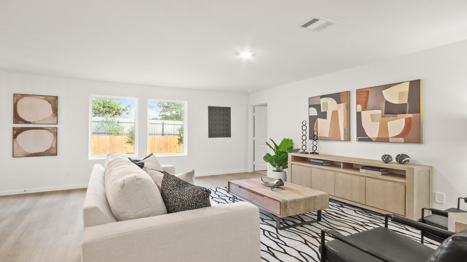 Spacious living area with vinyl flooring