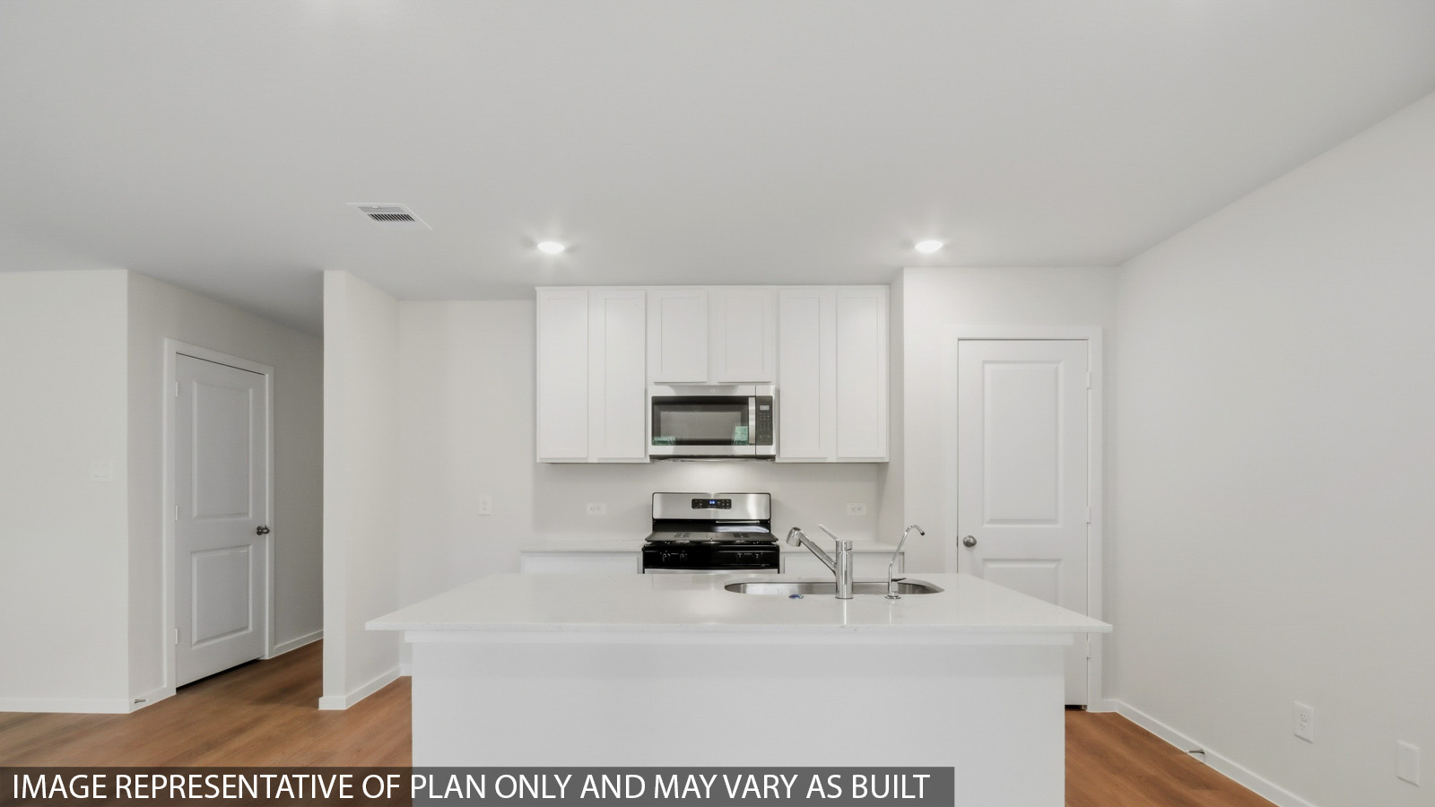 Kitchen with quartz countertops and an island and vinyl floor