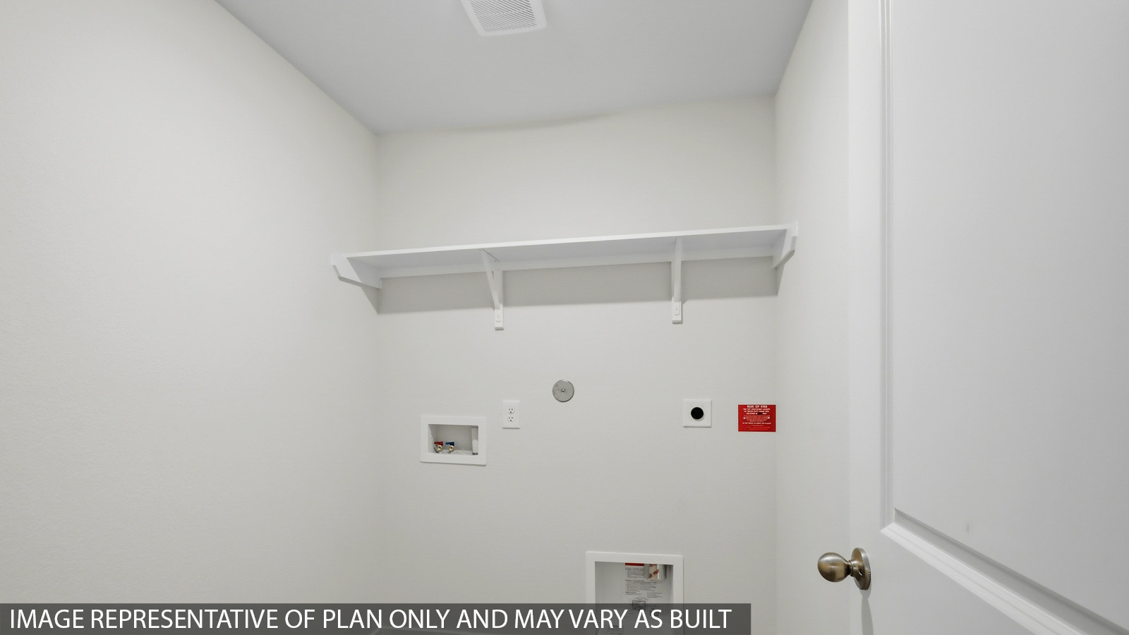 Utility room with storage located off the entry hallway and garage door