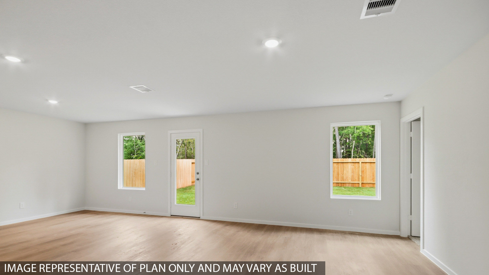 Spacious living area with vinyl flooring and bright windows in Willis TX