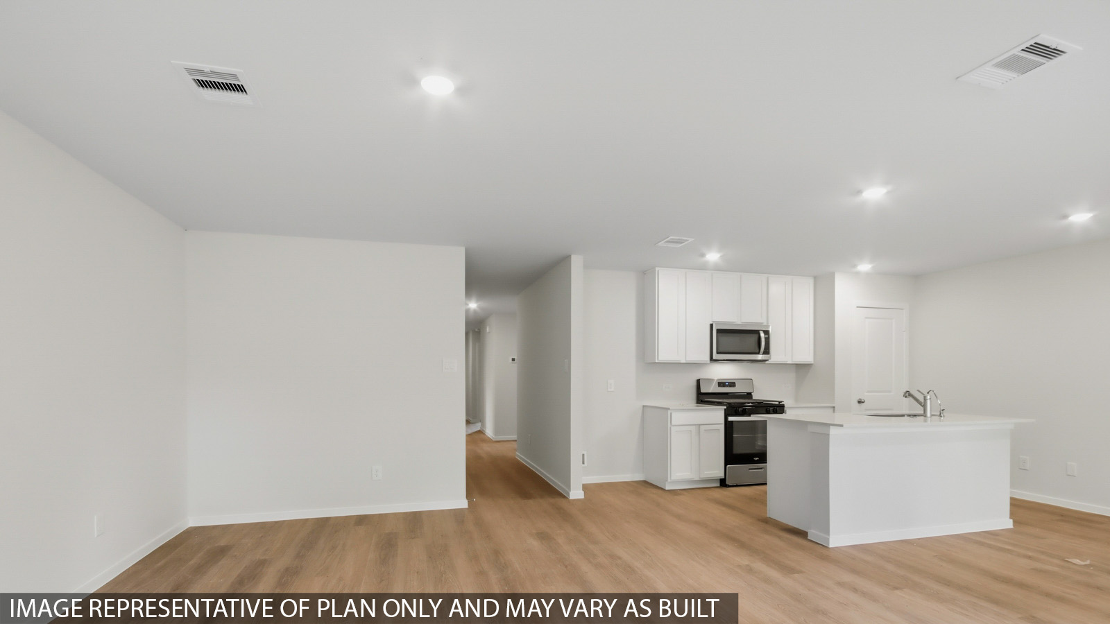 Kitchen with quartz countertops and an island and vinyl floor