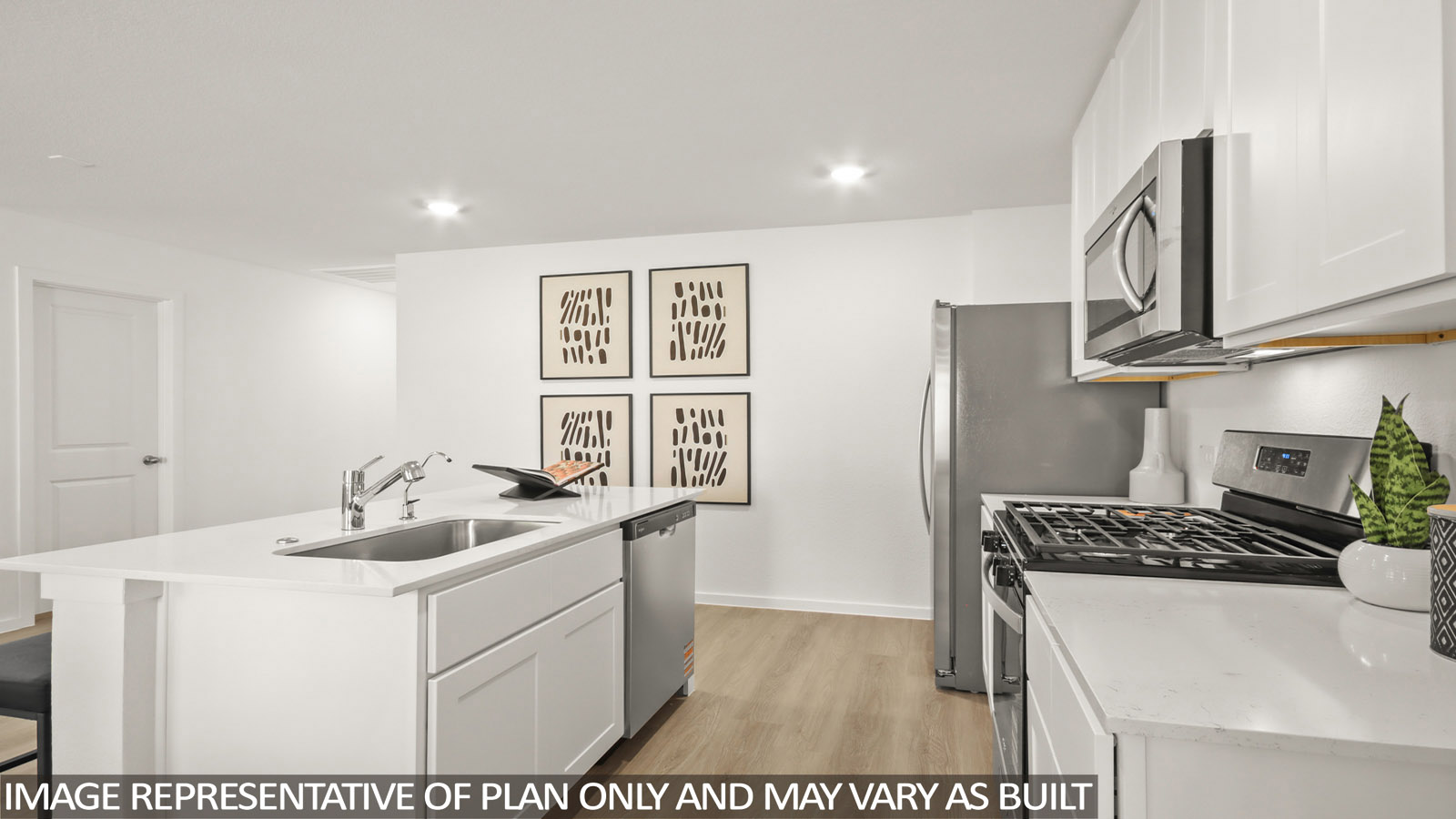 Kitchen with quartz countertops and an island and vinyl floor