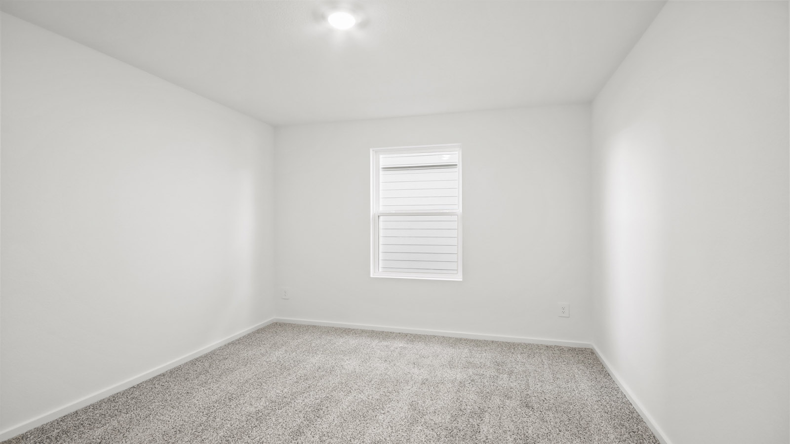 Secondary bedroom with carpet flooring