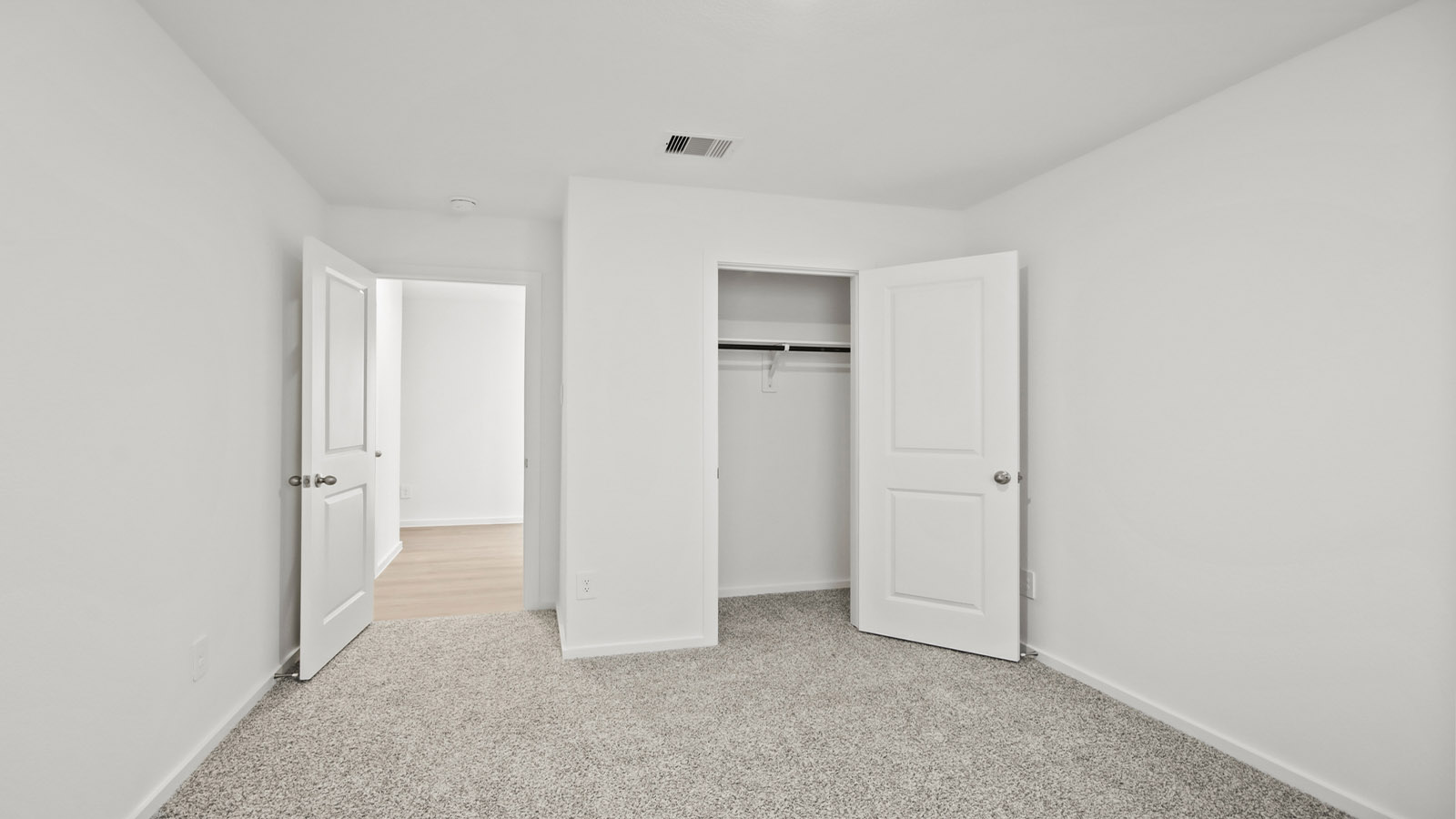 Secondary bedroom with carpet flooring