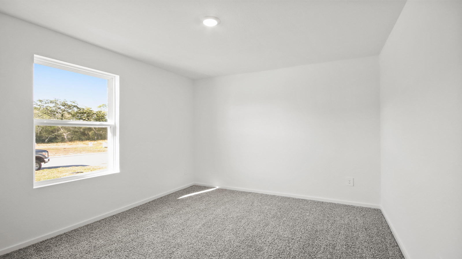 Secondary bedroom with carpet flooring