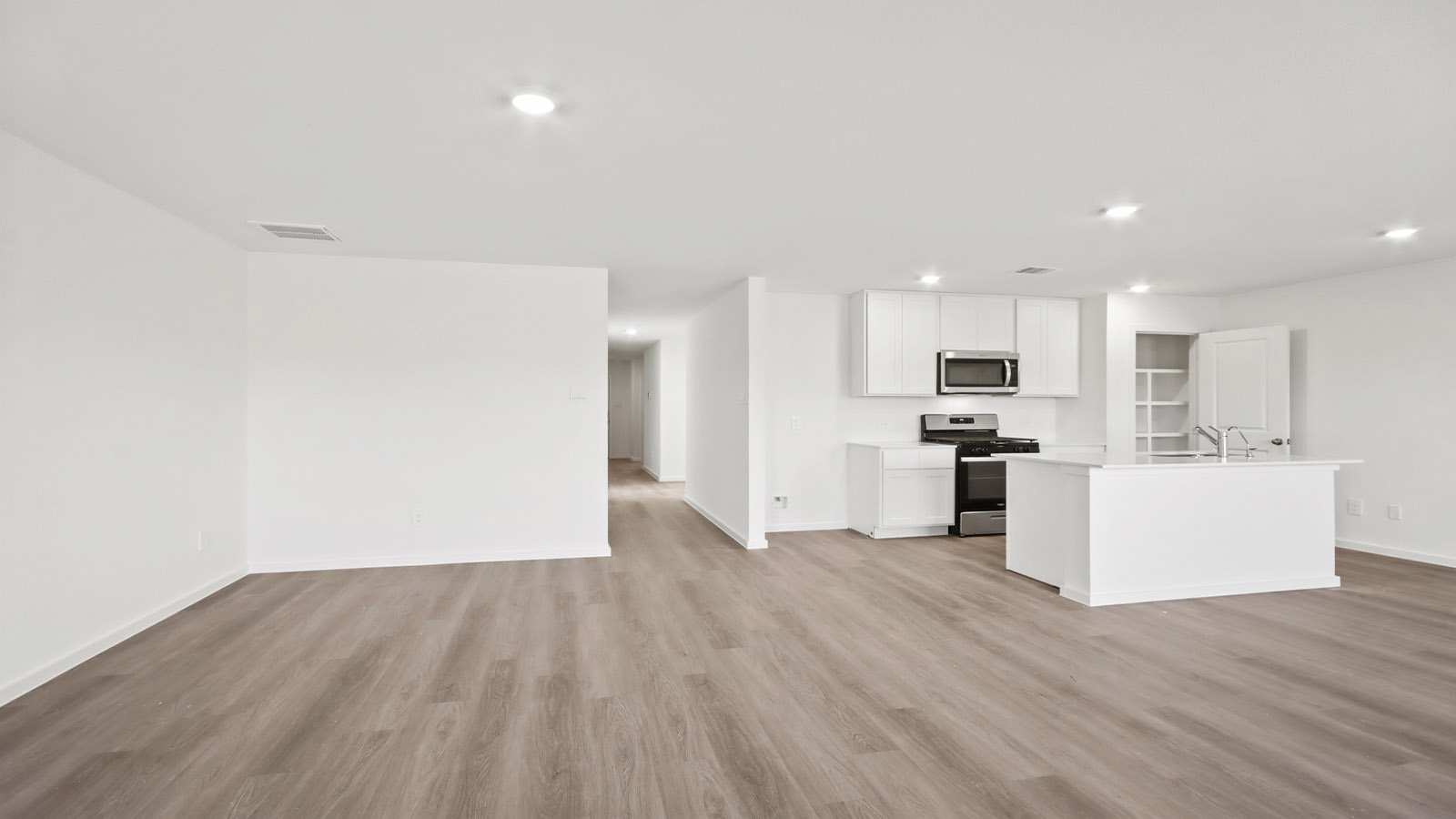 Spacious living area with vinyl flooring