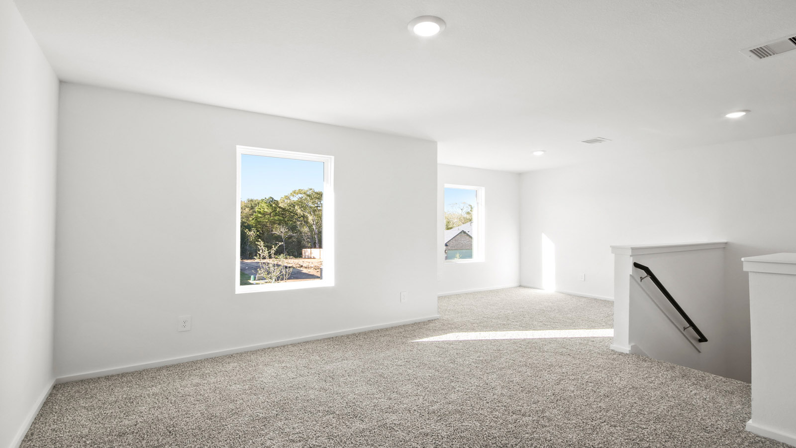 Second story game room with carpet flooring