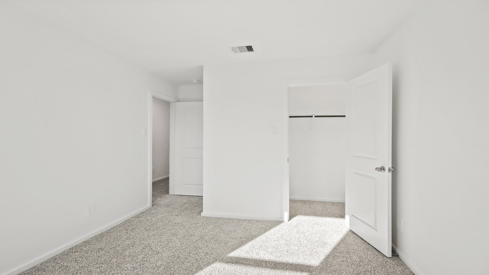 Secondary bedroom with carpet flooring