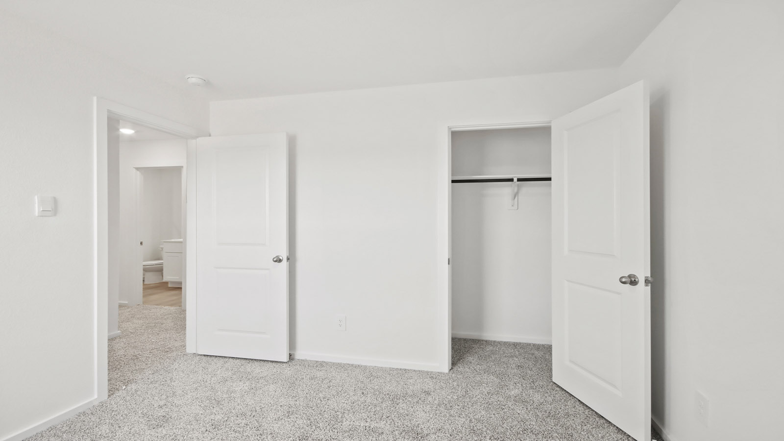 Secondary bedroom with carpet flooring