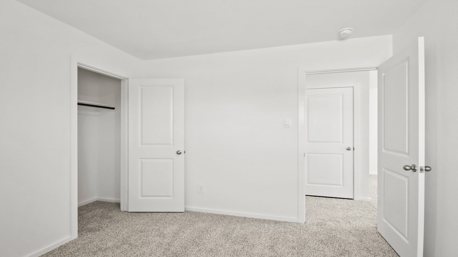 Secondary bedroom with carpet flooring