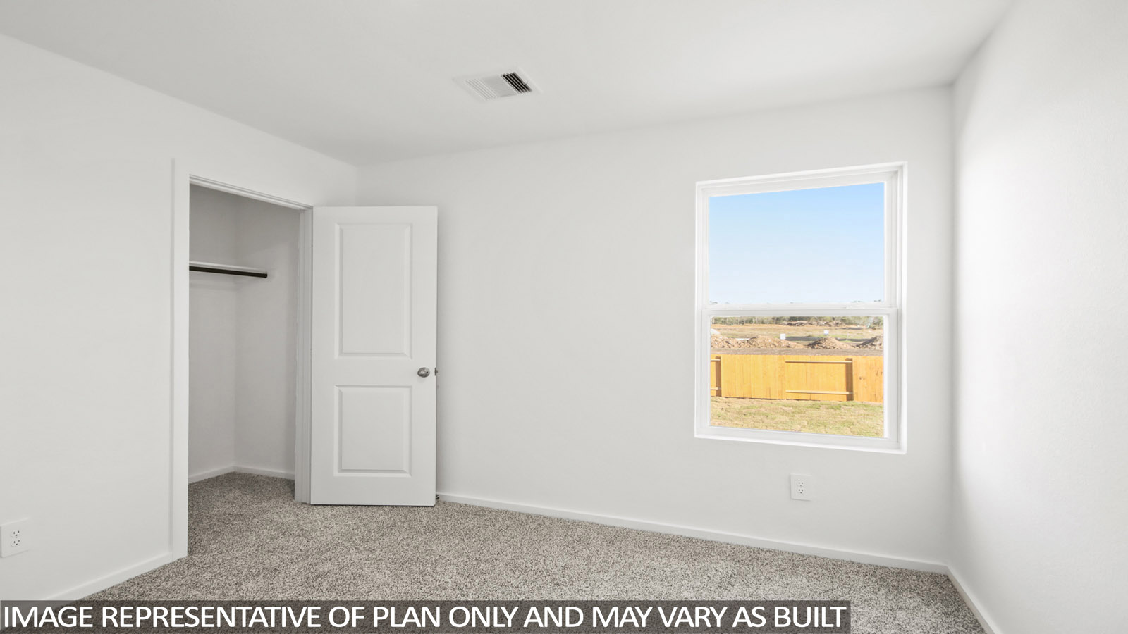 Second level secondary bedroom with carpet flooring and bright window